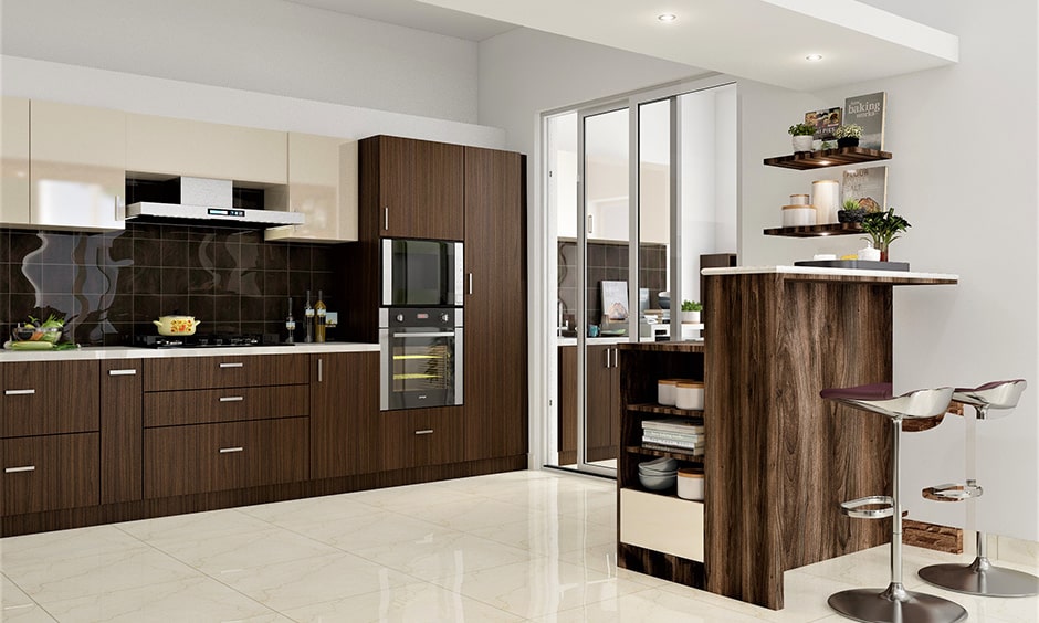 Sliding kitchen doors with glass gives space in this modular kitchen