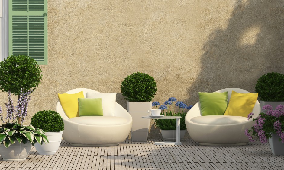 Small terrace garden ideas, moveable lounge chairs and planters around a nook creates a stunning terrace garden design.