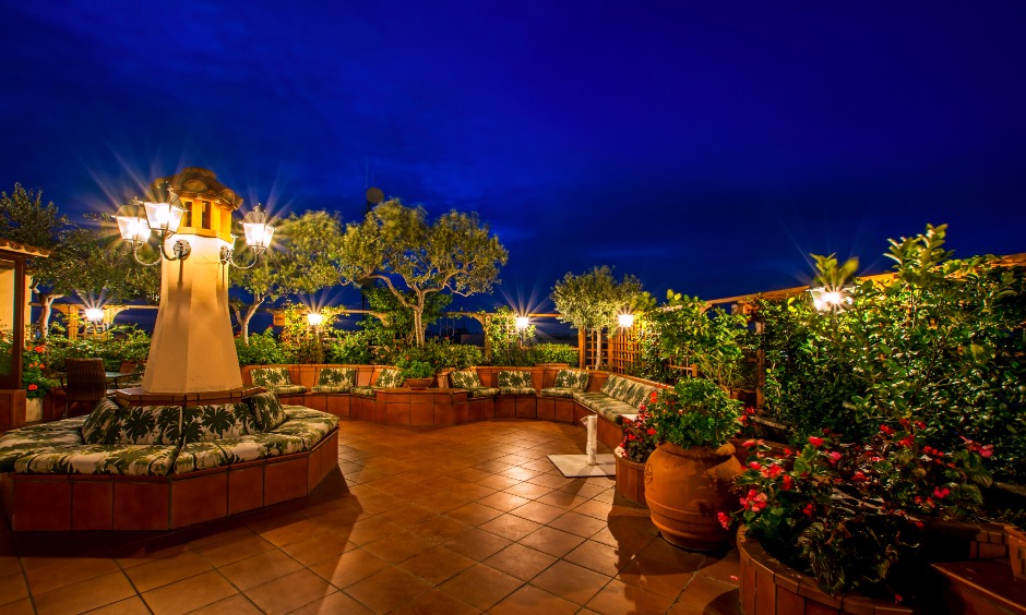 Tropical terrace garden design decked up with planters, lamp posts and comfy sofas are genuinely unique and flattering.