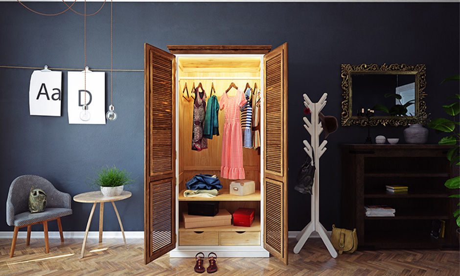 Open solid wood two-door wardrobe inside design with a clothes hanger rod and set of drawers in the bedroom.