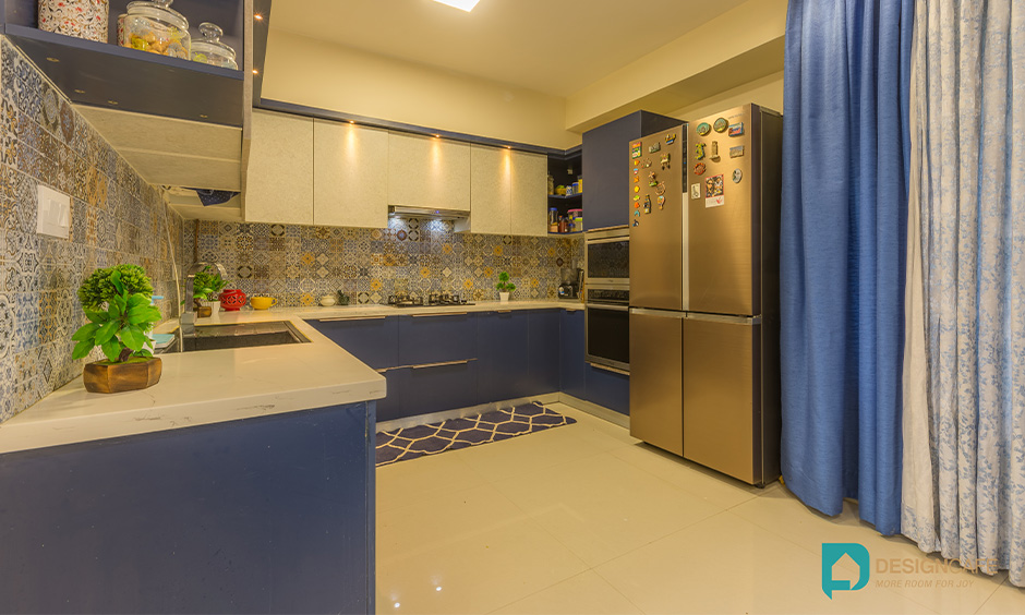 2bhk u shaped kitchen interior design with cabinets in blue and white laminate in Bengaluru look stunning.