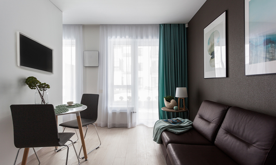 The blue aqua coloured curtain in the living cum dining room makes an impressive statement, aqua blue paint colour.