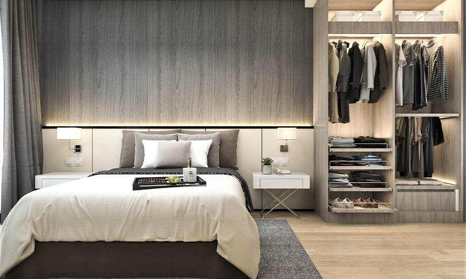 Grey open wardrobe designed with three hanging rods and pull-out shelves, bedroom wardrobe inside design for men.