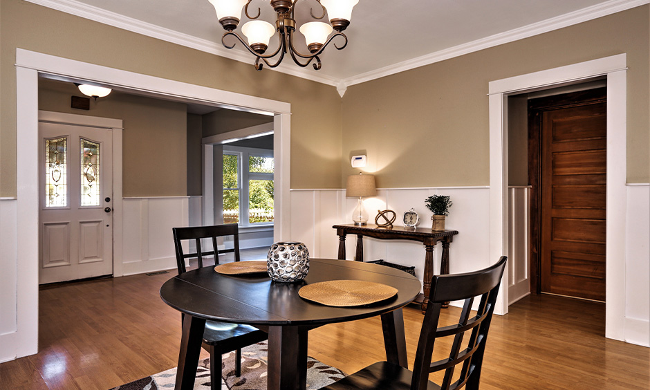 Best color for dining table, dining room with a round wooden table and two chairs in black colour looks bold.