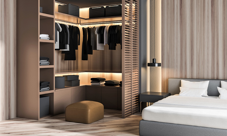 Corner wooden wardrobe inside design with rod hanger, shelves, baskets and boxes with backlighting look luxurious.