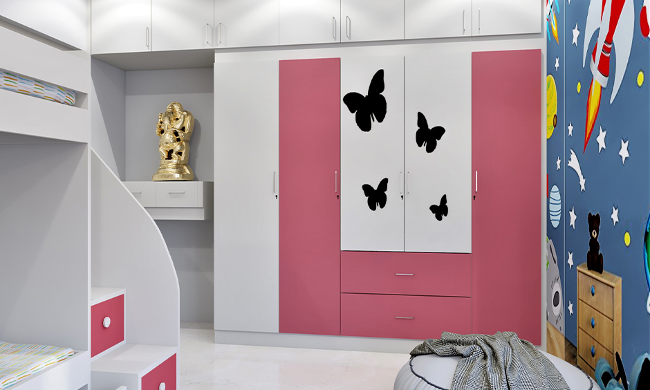 White and pink coloured wardrobe door decorated with animated stickers in the kids' bedroom, wardrobe decoration DIY.