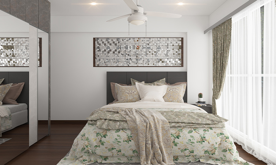 Grey and white bedroom with mirror artwork on the wall