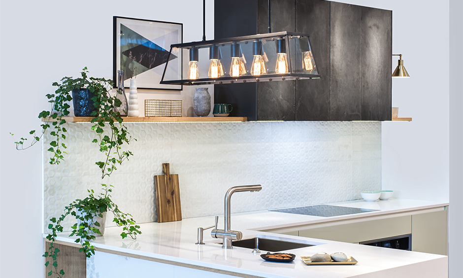 Hanging pendant light over kitchen sink with exposed bulbs look sleek and trendy