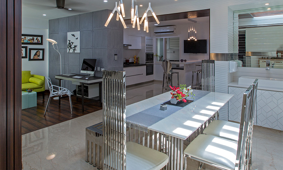 Dining room with a table and chairs made from stainless steel and white wood, independent house interior design.