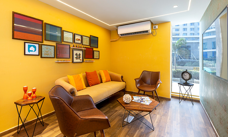 Bright yellow Indian style living room in design cafe Whitefield experience centre looks chic.