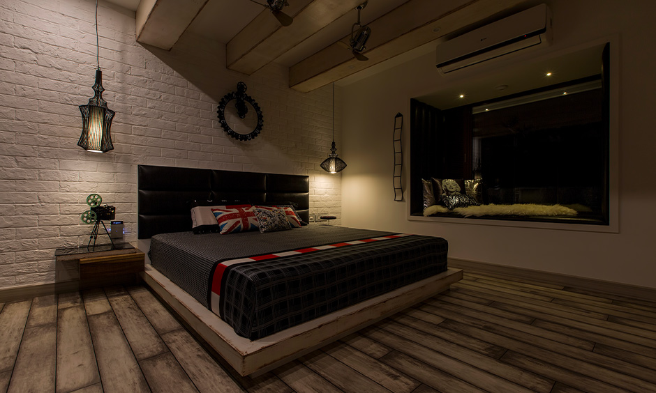 Independent house design, White bedroom with a black bed, antique lights and wooden ceiling brings industrial look.