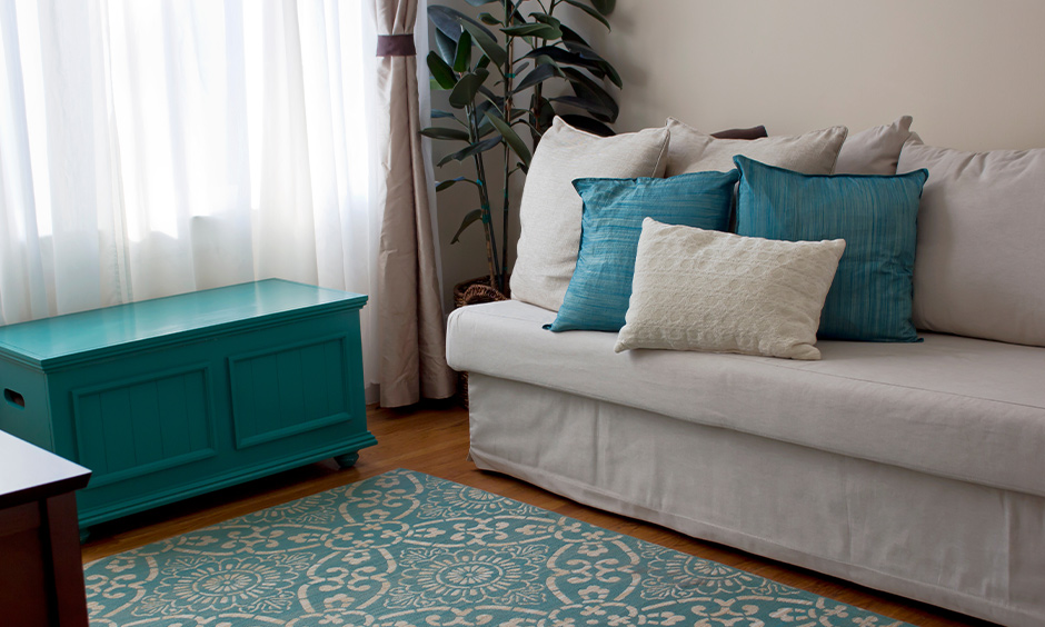 Living room with aqua blue coloured cabinet and cushions looks calming, aqua paint color for living room.