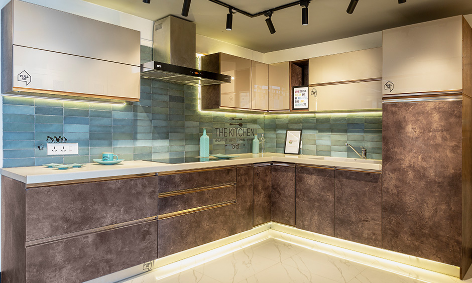 The L-shaped modern eclectic kitchen looks luxury and designed by design cafe interior designer in Whitefield.