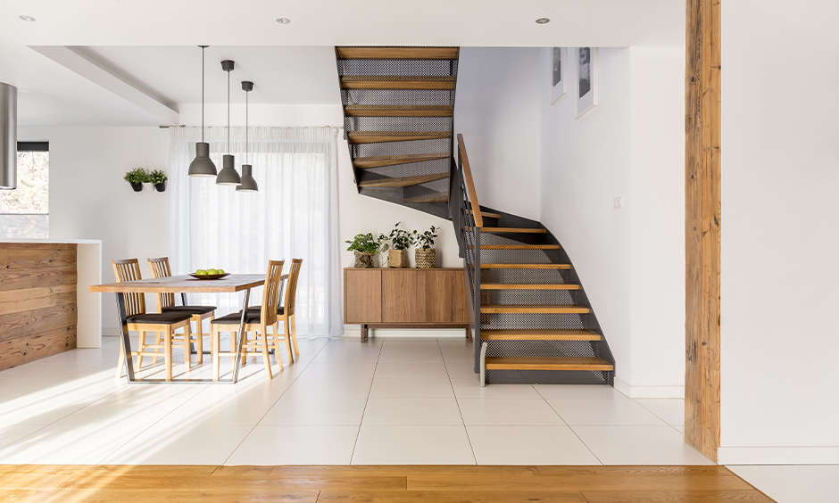 Open staircase with mesh and wood designed in the white dining area