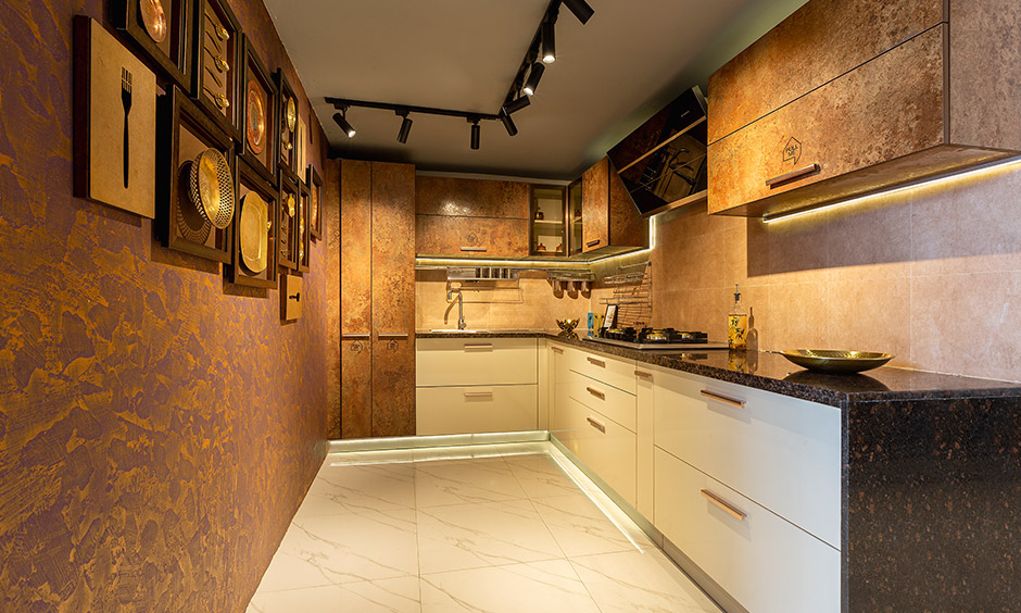 Modern rustic kitchen with cabinets and skirting drawer designed by design cafe is the best interior designer in Whitefield.