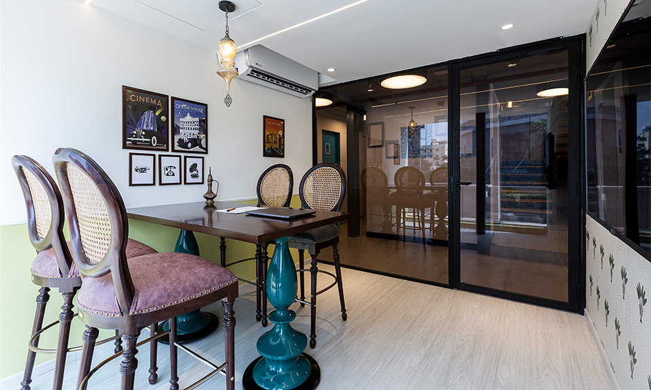 Indian style living room with high chairs and decoupage decor look adorable, Mumbai design cafe in experience centre.