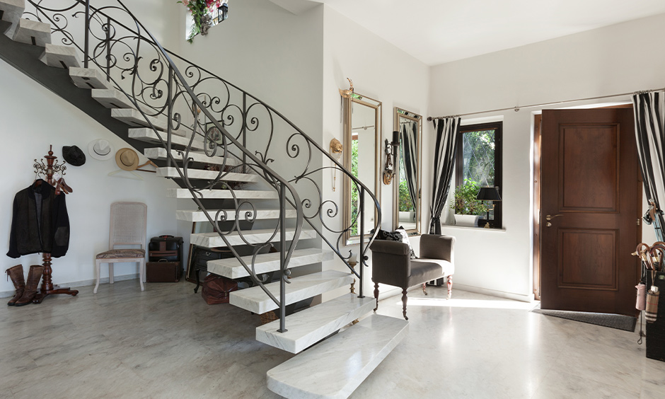 Open concept staircase with iron and marble in the entrance brings traditional with a modern touch