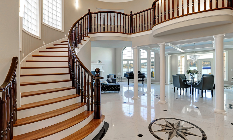 Staircase colour with light-brown treads, white risers and dark wood balustrades lends a classy and royal vibe