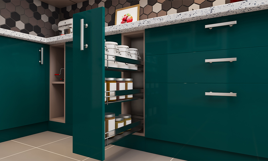 Kitchen storage solution with green coloured spice pull-out unit designed to hold smaller containers in it.