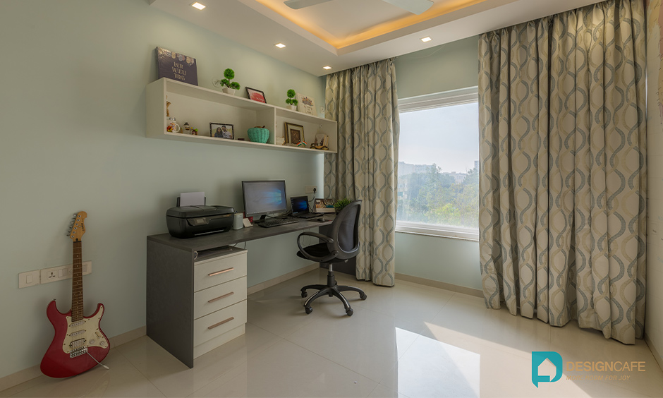 Minimalist light green study room with sophisticated table design is a simple interior design for 2bhk flat in Bengaluru Bhoganhalli.