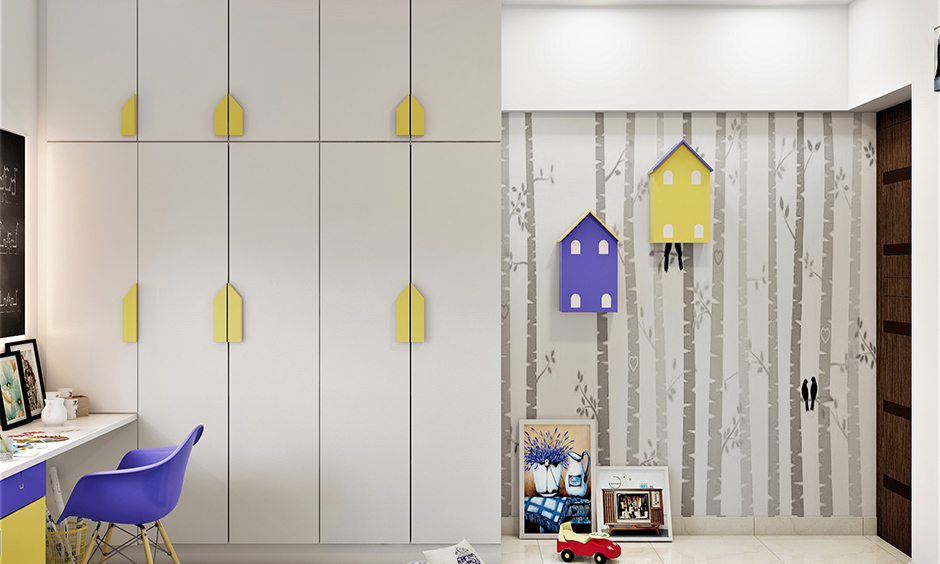 White wardrobe door knobs decorated in yellow house shape is how to decorate the wardrobe in kid bedroom.