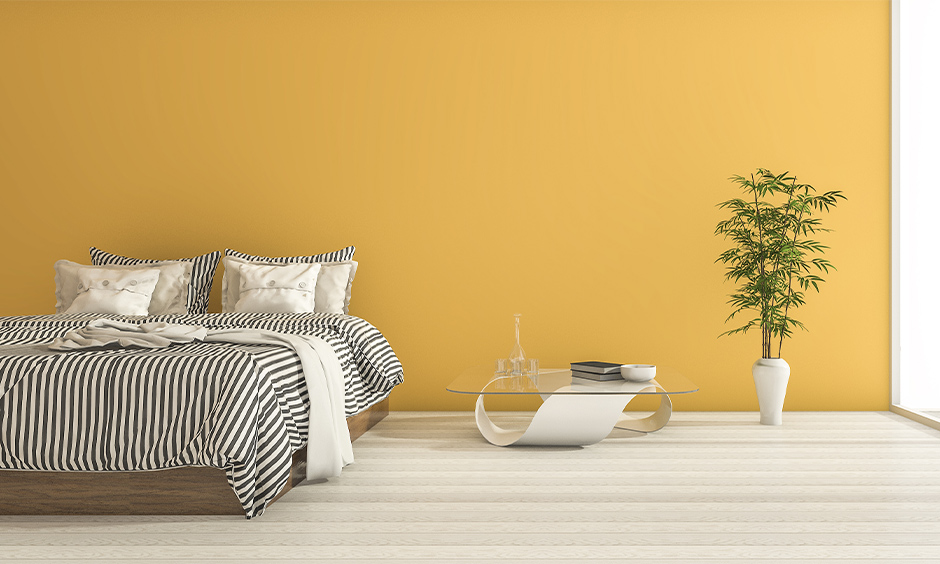 Yellow walls with sheer white curtains give your room a rich and luxurious