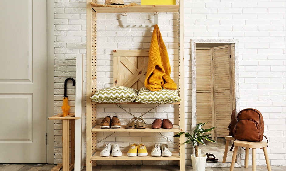 Light wooden rack home furniture design in the hall brings a rustic and warm vibe to the entryway space.