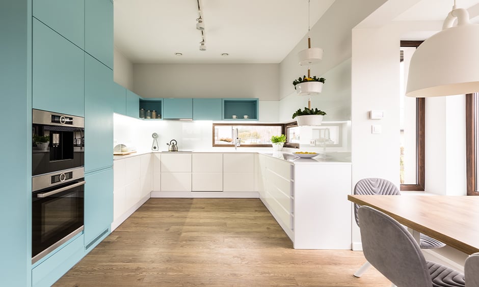 Baby blue kitchen cabinets with the wooden flooring