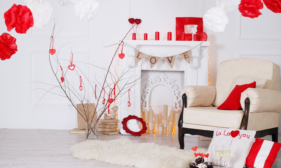 The room decor with homemade red candles, paper lanterns, and tree branch is the Valentine room decoration idea.