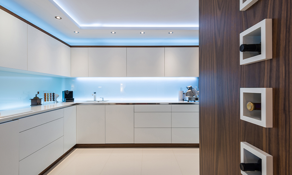 White kitchen with blue-toned lights under white cabinets looks refreshing is the led lights for kitchen cabinets.