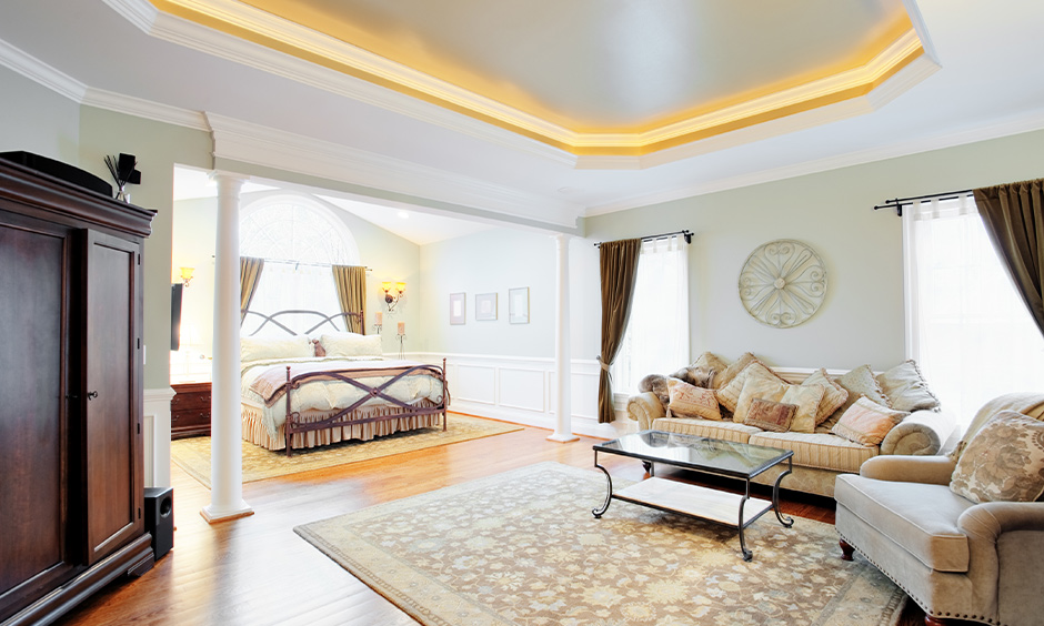 The contemporary living room has led strip light coving in the false ceiling corners.