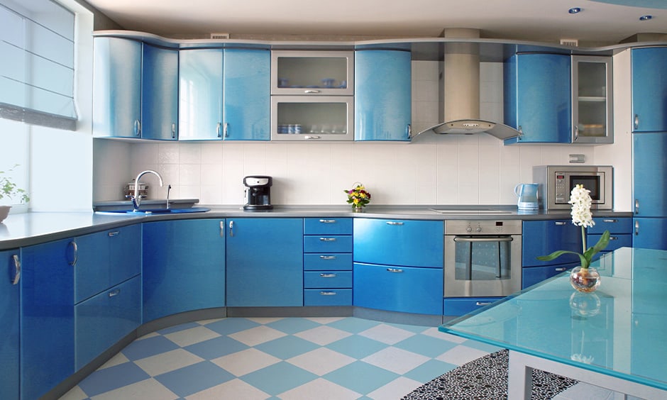 Cornflower blue kitchen cabinets with darker shades of the colour creates visual appeal in the kitchen