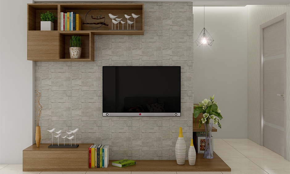 The cage pendant light hanging next to the tv unit looks beautiful is the hanging light for living room.