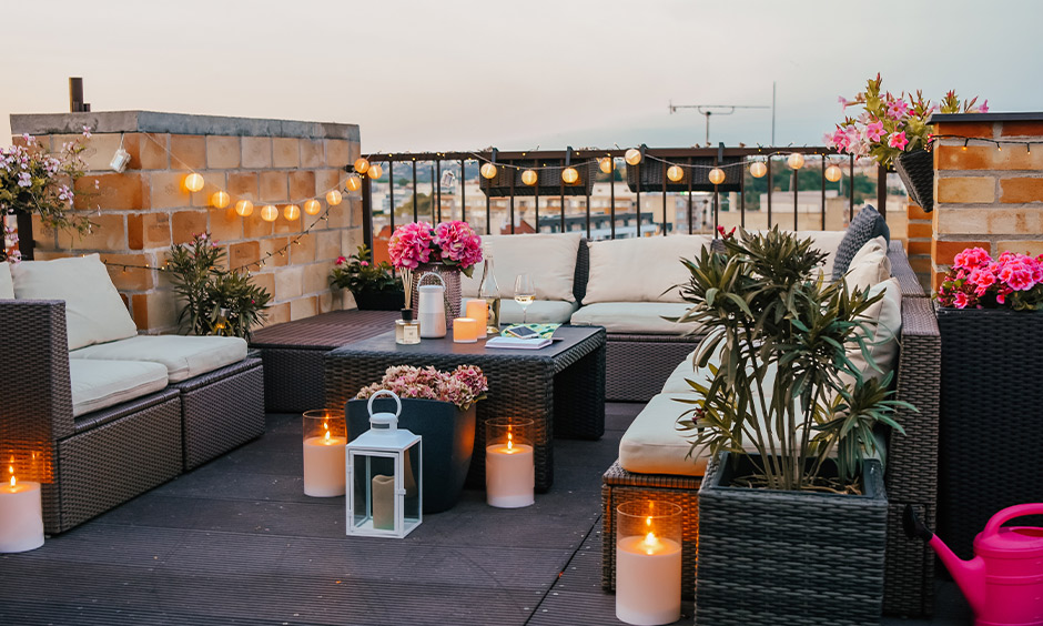 Balcony decorated for valentine day with flowers, plants, fairy lights and table lamps is DIY valentine decorations.