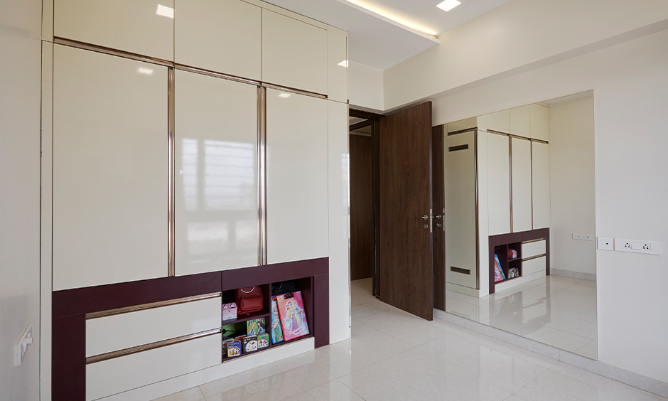 Kids bedroom interiors in Mumbai with floor-to-ceiling wooden wardrobe executed by top designer