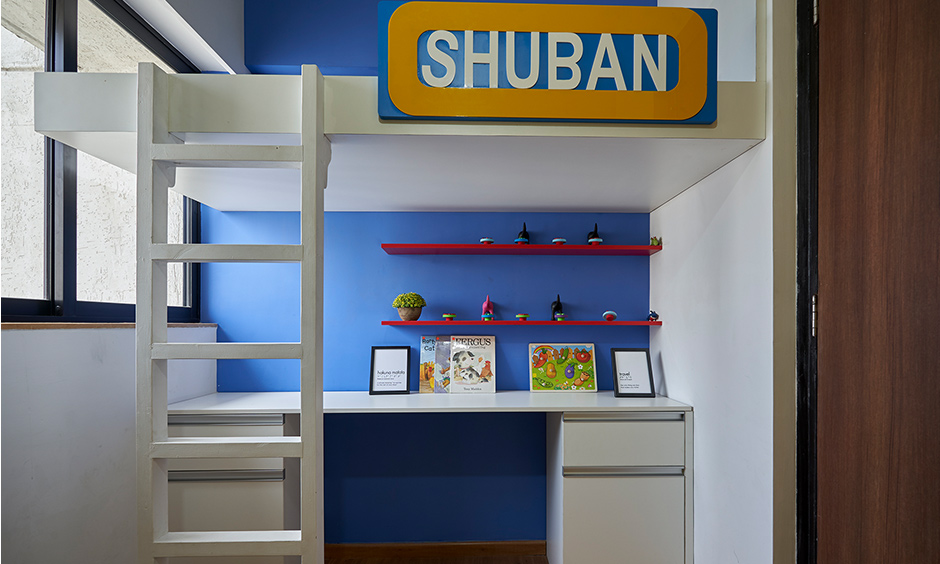 The small kid's bedroom has a bunk bed with a study table in minimal design in dombivil mumbai