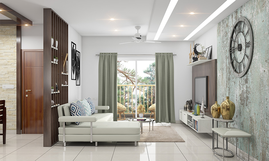 The white living room has a layered modern cove light ceiling.