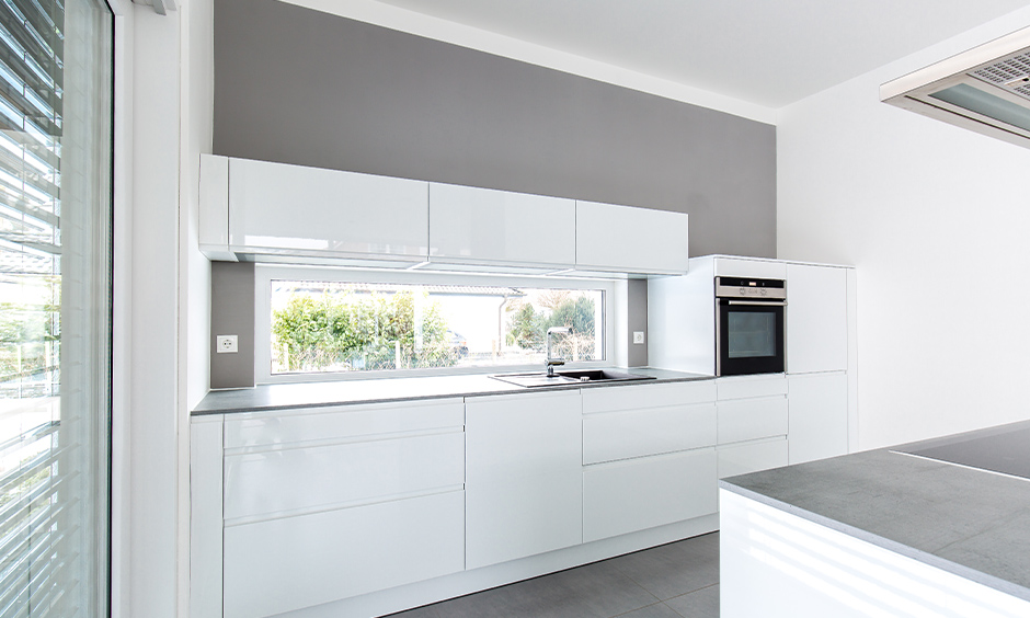 All-white kitchen with modern high gloss white kitchen cabinets look classy.