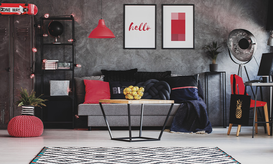 Red color living room decor, grey living room with pops of red colours light, cushion and chair lends colourfulness.