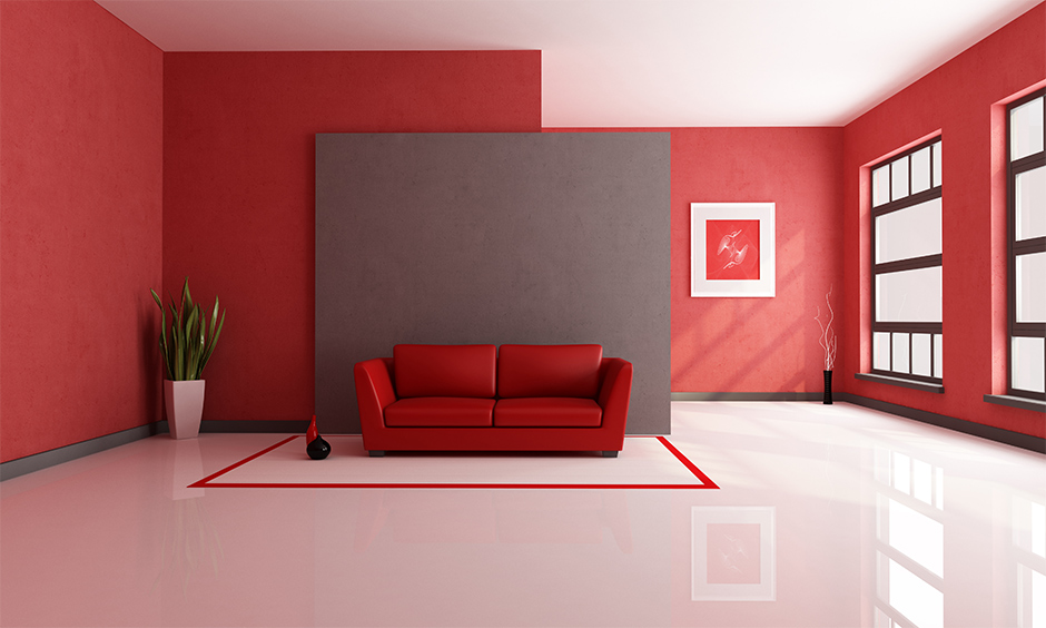 Red living room with red sofa in front of a grey background looks minimalist.