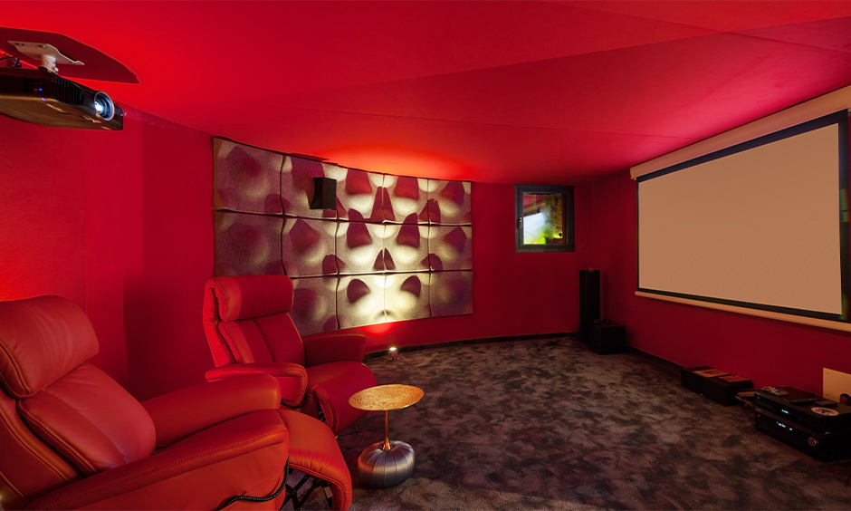 Red living room home theatre with two red recliner chairs brings luxury feel is red interior design living room.