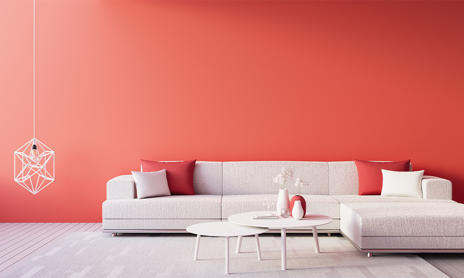 Red wall in the living room with minimal design adds boldness to space.