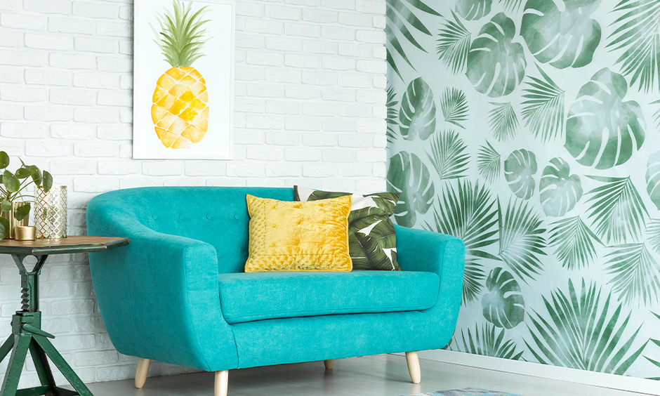 The living room has a sofa in turquoise and a pillow in a yellow analogous color scheme that brings aesthetic.