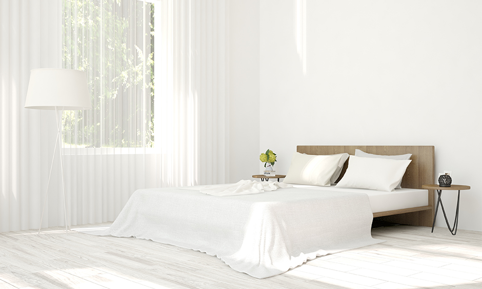 Two types of white curtains for white walls in a bedroom with different textures look classy.