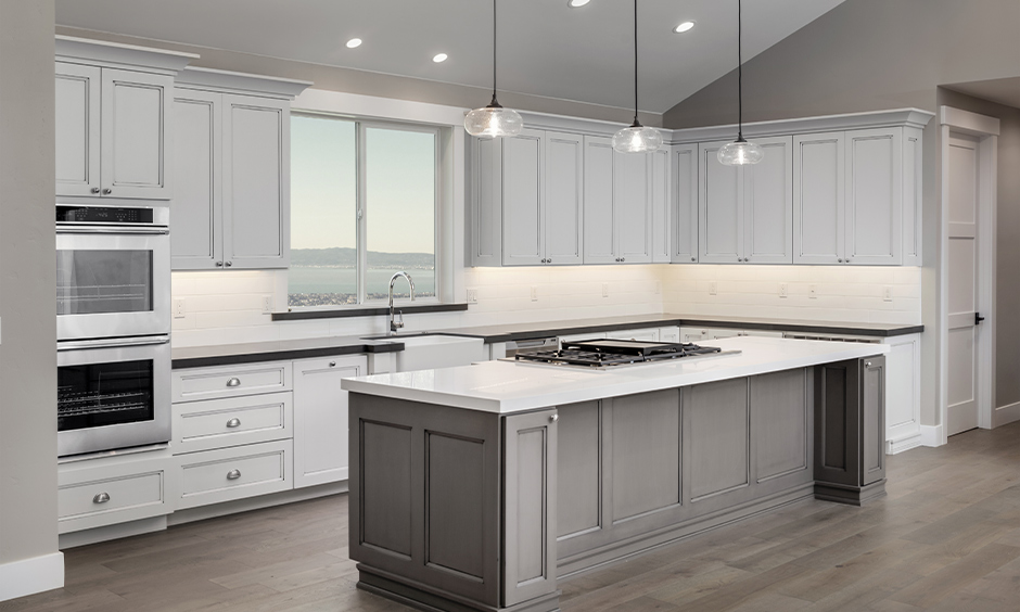 White and grey island kitchen with under cabinet kitchen lighting option in white light is a classic look.