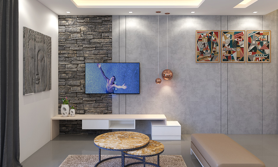 Copper round pendant lights hanging next to the tv unit adds a touch of luxury is the wall hanging lights for living room.