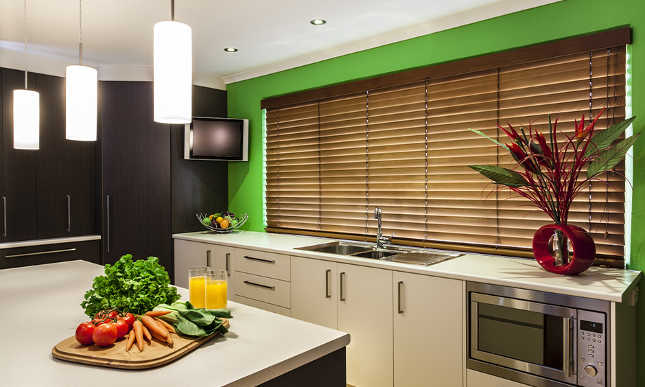 Kitchen island's wooden single blinders curtain complements with green wall