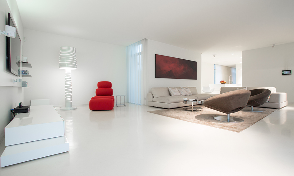 White living room with white marble flooring designed in minimal and colourful types of furniture looks splendid.