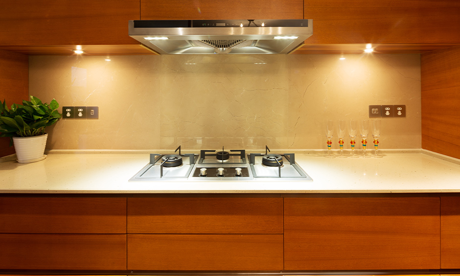 The kitchen with lights under the wooden cabinet next to the chimney is simple wireless led lights for kitchen cabinets.