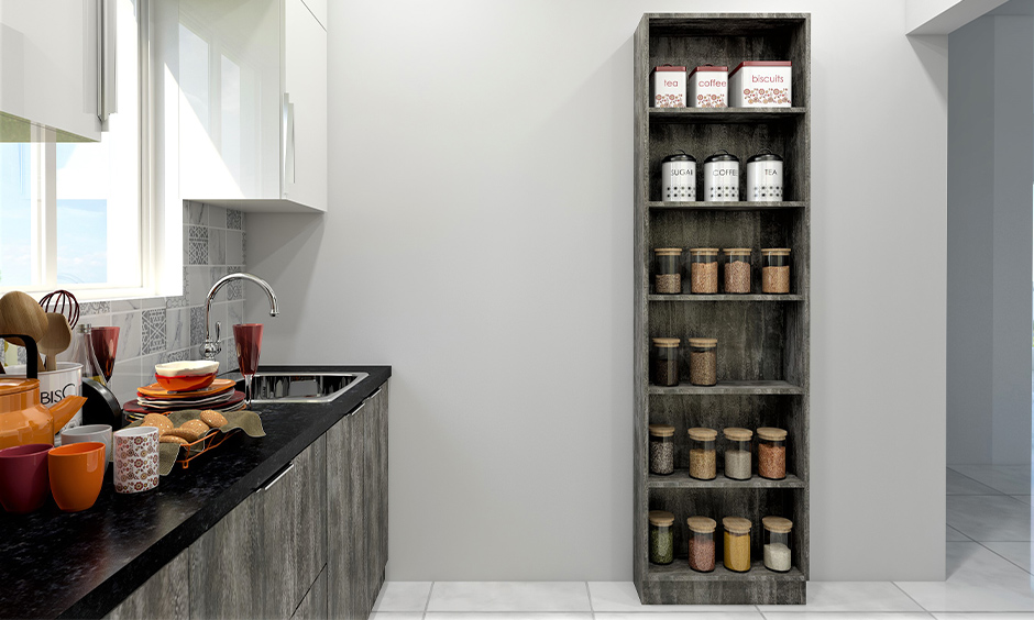 Tall wood kitchen pantry cabinet with open shelves against white wall lends a rustic look to the area.